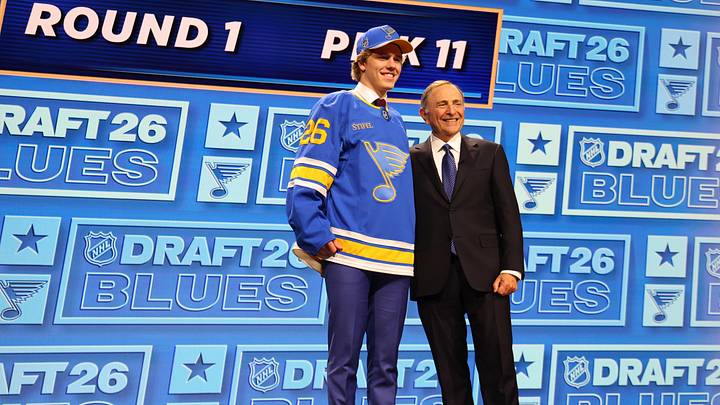 Jun 26, 2026; Buffalo, New York, USA; Tynan Lawrence poses beside NHL commissioner Gary Bettman after being selected with the eleventh pick in the first round of the 2026 NHL Draft by the St. Louis Blues at KeyBank Center. Mandatory Credit: Timothy T. Ludwig-Imagn Images