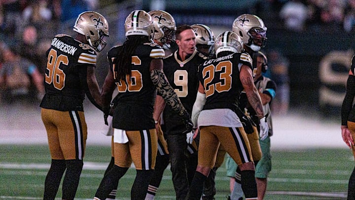 Oct 17, 2024; New Orleans, Louisiana, USA; Former New Orleans Saints quarterback Drew Brees on the field for the coin toss with New Orleans Saints cornerback Marshon Lattimore (23) and linebacker Demario Davis (56) against the Denver Broncos during the first half at Caesars Superdome. Mandatory Credit: Stephen Lew-Imagn Images Oct 17, 2024; New Orleans, Louisiana, USA; Former New Orleans Saints quarterback Drew Brees on the field for the coin toss with New Orleans Saints cornerback Marshon Lattimore (23) and linebacker Demario Davis (56) against the Denver Broncos during the first half at Caesars Superdome. Mandatory Credit: Stephen Lew-Imagn Images