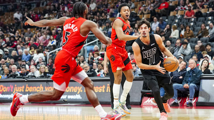 Apr 12, 2026; Toronto, Ontario, CAN; Brooklyn Nets Ben Saraf (77) drives to the basket against Toronto Raptors Immanuel Quickley (5) during the first half at Scotiabank Arena. Mandatory Credit: Kevin Sousa-Imagn Images
