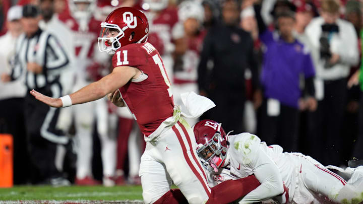 Alabama Crimson Tide defensive back Malachi Moore (13) brings down Oklahoma Sooners quarterback Jackson Arnold (11)