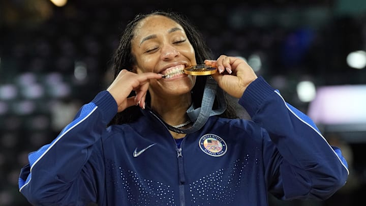 Aug 11, 2024; Paris, France; United States forward A'Ja Wilson (9) celebrates with the gold medal after defeating France in the women's gold medal game during the Paris 2024 Olympic Summer Games at Accor Arena. 