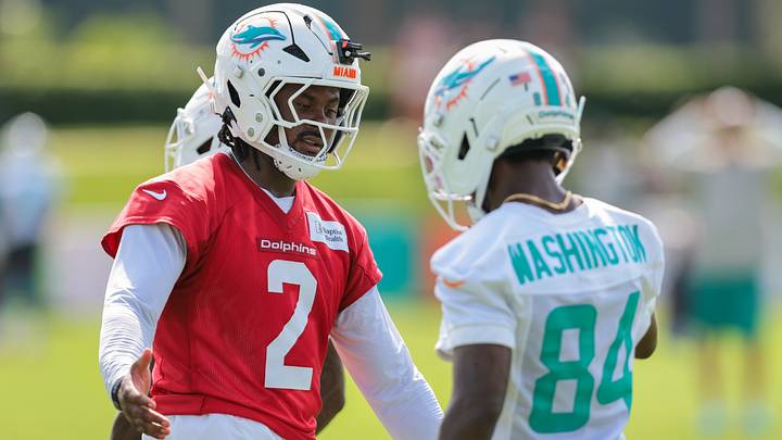 Miami Dolphins quarterback Malik Willis (2) shakes hands with wide receiver Tahj Washington (84) during practice at the Baptist Health Training Complex. Miami Dolphins quarterback Malik Willis (2) shakes hands with wide receiver Tahj Washington (84) during practice at the Baptist Health Training Complex.