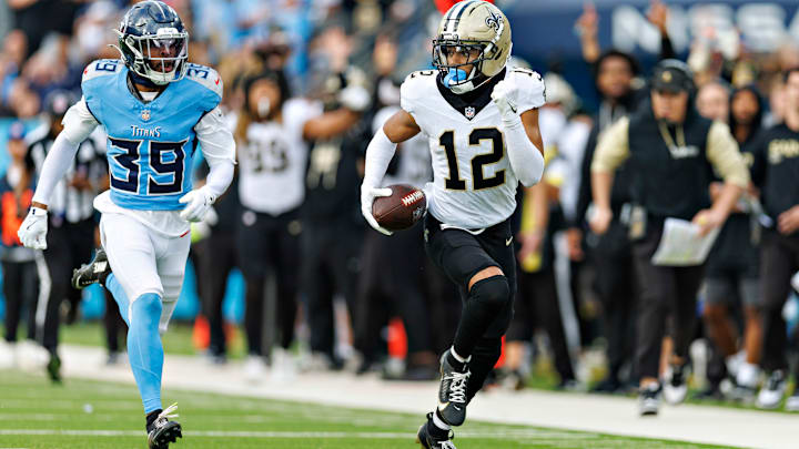 New Orleans Saints WR Chris Olave (12) runs with the ball, away from Tennessee Titans' CB Darrell Baker Jr. (39) on Dec. 28, 2025