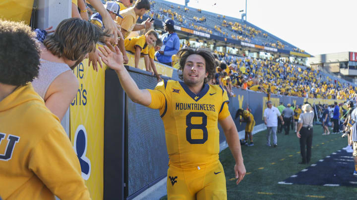 Aug 30, 2025; Morgantown, West Virginia, USA; West Virginia Mountaineers quarterback Nicco Marchiol (8) celebrates with fans after defeating the Robert Morris Colonials at Milan Puskar Stadium. Mandatory Credit: Ben Queen-Imagn Images
