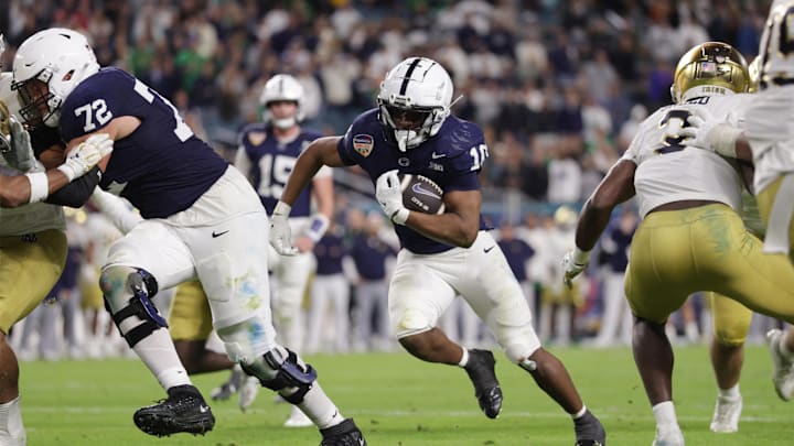 Penn State Nittany Lions running back Nicholas Singleton (10) runs the ball in the second half against the Notre Dame Fighting Irish in the Orange Bowl at Hard Rock Stadium.