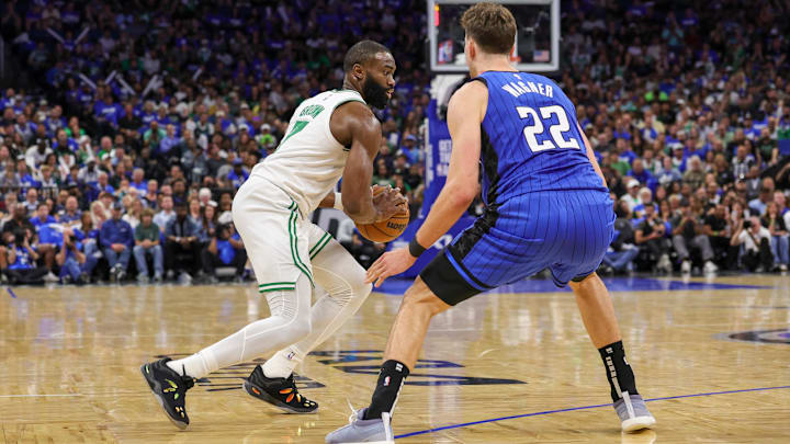 Apr 25, 2025; Orlando, Florida, USA: Boston Celtics guard Jaylen Brown (7) moves the ball in front of Orlando Magic forward Franz Wagner (22) during the second half of game three of first round for the 2024 NBA Playoffs at Kia Center. Mandatory Credit: Mike Watters-Imagn Images