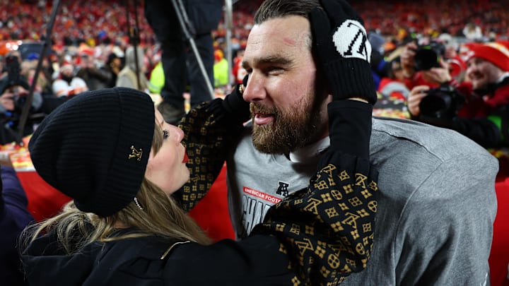 Recording artist Taylor Swift  and Kansas City Chiefs tight end Travis Kelce (87) react after the AFC Championship game against the Buffalo Bills at GEHA Field at Arrowhead Stadium.