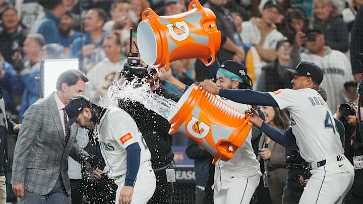 Oct 17, 2025; Seattle, Washington, USA; Seattle Mariners shortstop J.P. Crawford (3) and center fielder Julio Rodriguez (44) pour water on third baseman Eugenio Suarez (28) after game five of the ALCS round against the Toronto Blue Jays for the 2025 MLB playoffs at T-Mobile Park. Mandatory Credit: Stephen Brashear-Imagn Images Oct 17, 2025; Seattle, Washington, USA; Seattle Mariners shortstop J.P. Crawford (3) and center fielder Julio Rodriguez (44) pour water on third baseman Eugenio Suarez (28) after game five of the ALCS round against the Toronto Blue Jays for the 2025 MLB playoffs at T-Mobile Park. Mandatory Credit: Stephen Brashear-Imagn Images