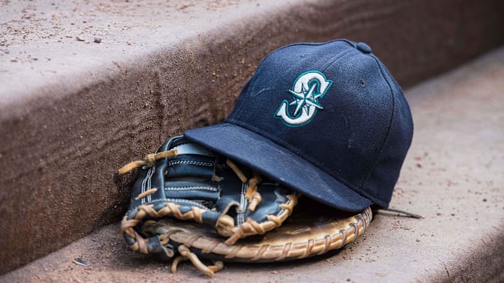 Aug 18, 2015; Arlington, TX, USA; A view of a Seattle Mariners ball cap and glove during the game between the Texas Rangers and the Seattle Mariners at Globe Life Park in Arlington. The Mariners defeat the Rangers 3-2. Mandatory Credit: Jerome Miron-Imagn Images Aug 18, 2015; Arlington, TX, USA; A view of a Seattle Mariners ball cap and glove during the game between the Texas Rangers and the Seattle Mariners at Globe Life Park in Arlington. The Mariners defeat the Rangers 3-2. Mandatory Credit: Jerome Miron-Imagn Images