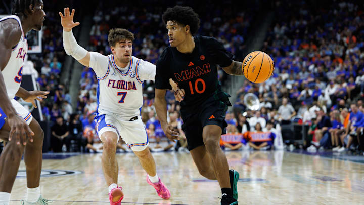 Nov 16, 2025; Jacksonville, Florida, USA; Florida Gators guard Urban Klavzar (7) defends Miami Hurricanes guard Tru Washington (10) during the second half at VyStar Veterans Memorial Arena. Mandatory Credit: Matt Pendleton-Imagn Images