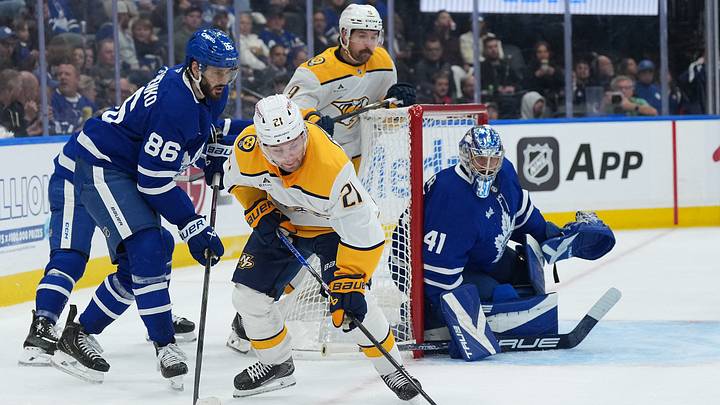 Oct 6, 2026; Toronto, Ontario, CAN;  Toronto Maple Leafs right wing Kirill Marchenko (86) battles for the puck with Nashville Predators left wing Nils Hoglander (21) during the second period at Scotiabank Arena.  Mandatory Credit: Nick Turchiaro-Imagn Images