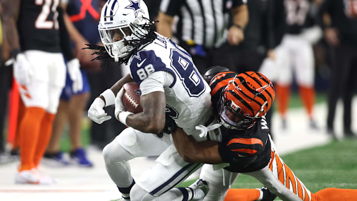Dec 9, 2024; Arlington, Texas, USA; Dallas Cowboys wide receiver CeeDee Lamb (88) is tackled by Cincinnati Bengals cornerback Marco Wilson (42) in the first quarter at AT&T Stadium. Mandatory Credit: Tim Heitman-Imagn Images