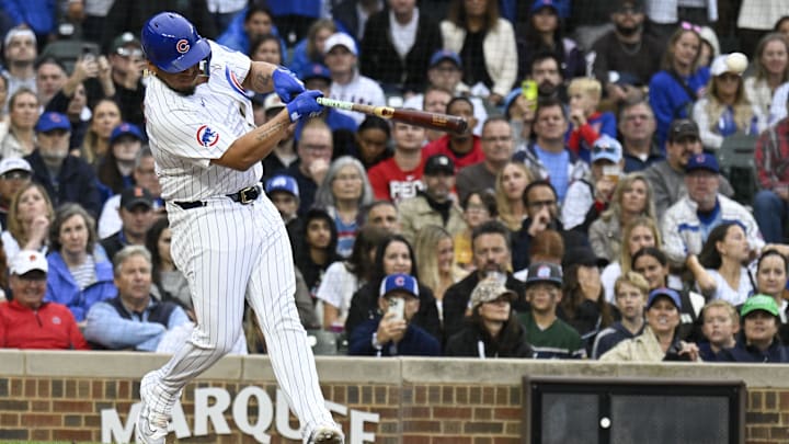 Sep 28, 2024; Chicago, Illinois, USA; Chicago Cubs third baseman Isaac Paredes (17) hits an RBI single during the eighth inning against the Cincinnati Reds at Wrigley Field. Sep 28, 2024; Chicago, Illinois, USA; Chicago Cubs third baseman Isaac Paredes (17) hits an RBI single during the eighth inning against the Cincinnati Reds at Wrigley Field.