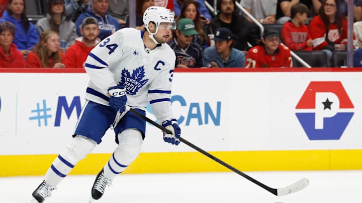 Oct 11, 2025; Detroit, Michigan, USA;  Toronto Maple Leafs center Auston Matthews (34) skates with the puck in the second period against the Detroit Red Wings at Little Caesars Arena. Mandatory Credit: Rick Osentoski-Imagn Images