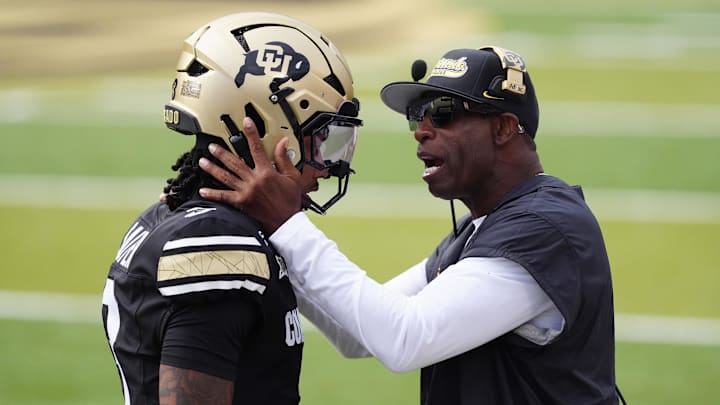 Aug 29, 2025; Boulder, Colorado, USA; Colorado Buffaloes head coach Deion Sanders congratulates Colorado Buffaloes quarterback Kaidon Salter (3) following a touchdown pass in the first quarter against the Georgia Tech Yellow Jackets at Folsom Field. Mandatory Credit: Ron Chenoy-Imagn Images