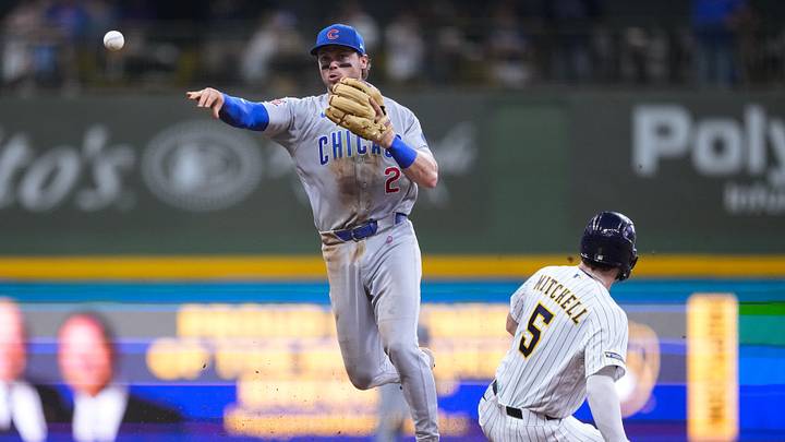 Chicago Cubs second baseman Nico Hoerner turns a double play against the Milwaukee Brewers.