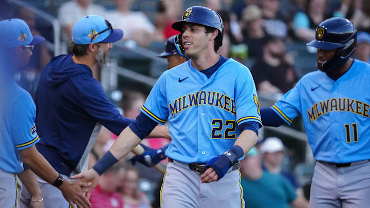 Brewers outfielder Christian Yelich (22) celebrates scoring against the Diamondbacks during a spring training game at Salt River Fields on March 20, 2026.