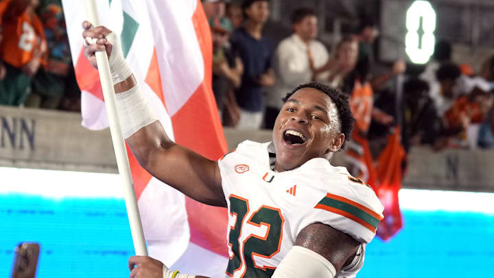Oct 5, 2024; Berkeley, California, USA; Miami Hurricanes linebacker Raul Aguirre Jr. (32) carries a flag after defeating the California Golden Bears at California Memorial Stadium. Mandatory Credit: Darren Yamashita-Imagn Images