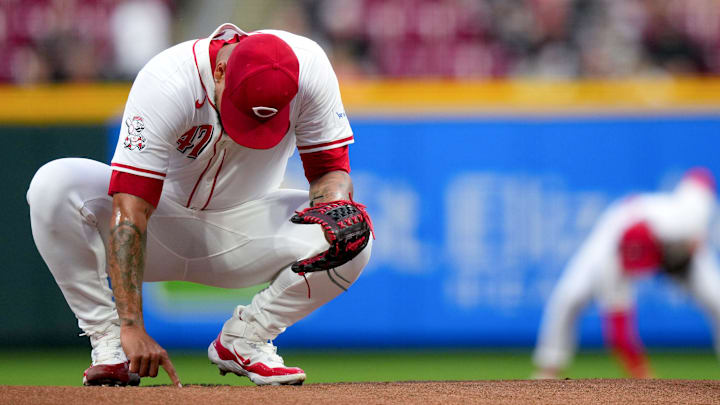 Cincinnati Reds pitcher Frankie Montas (47) writes on the mound as Cincinnati Reds second base