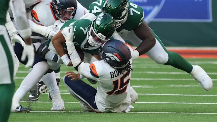 Oct 12, 2025; Tottenham, United Kingdom; New York Jets quarterback Justin Fields (7) is tackled by Denver Broncos linebacker Nik Bonitto (15) during an NFL International Series game at Tottenham Hotspur Stadium. Oct 12, 2025; Tottenham, United Kingdom; New York Jets quarterback Justin Fields (7) is tackled by Denver Broncos linebacker Nik Bonitto (15) during an NFL International Series game at Tottenham Hotspur Stadium.