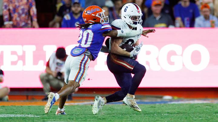 Sep 5, 2026; Gainesville, Florida, USA;  Florida Atlantic Owls wide receiver Branden Hoch (0) makes a catch over Florida Gators star Kanye Clark (20) during the first half at Ben Hill Griffin Stadium.  Mandatory Credit: Matt Pendleton-Imagn Images