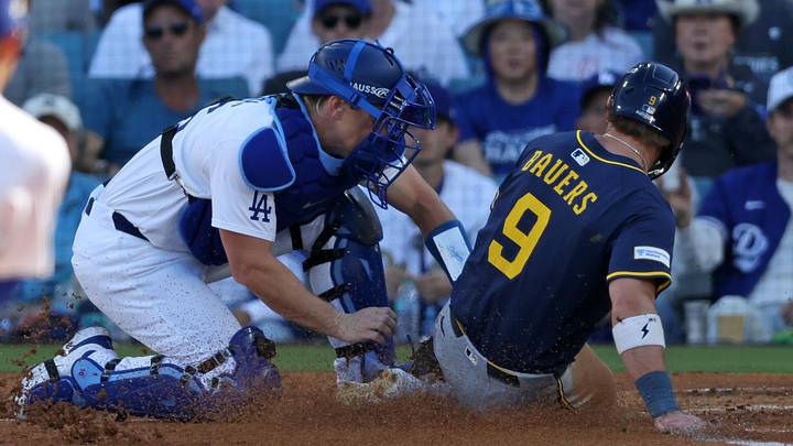 Oct 16, 2025; Los Angeles, California, USA; Los Angeles Dodgers catcher Will Smith (16) gets the out at home plate on Milwaukee Brewers first baseman Jake Bauers (9) in the second inning during game three of the NLCS round for the 2025 MLB playoffs at Dodger Stadium. Mandatory Credit: Kiyoshi Mio-Imagn Images Oct 16, 2025; Los Angeles, California, USA; Los Angeles Dodgers catcher Will Smith (16) gets the out at home plate on Milwaukee Brewers first baseman Jake Bauers (9) in the second inning during game three of the NLCS round for the 2025 MLB playoffs at Dodger Stadium. Mandatory Credit: Kiyoshi Mio-Imagn Images