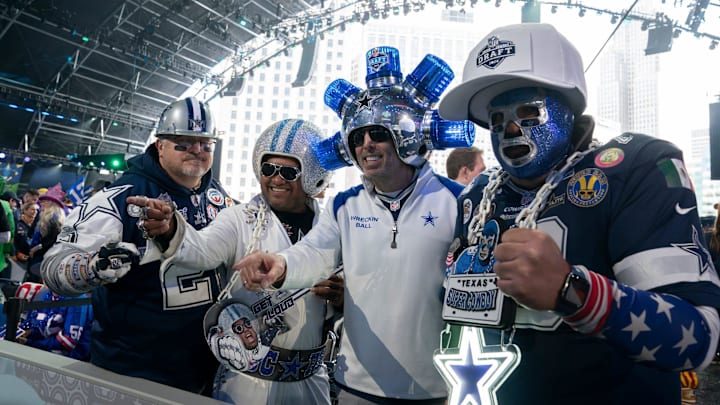 Dallas Cowboys fans pose in the main theater for the first day of the NFL Draft in Detroit. Dallas Cowboys fans pose in the main theater for the first day of the NFL Draft in Detroit.