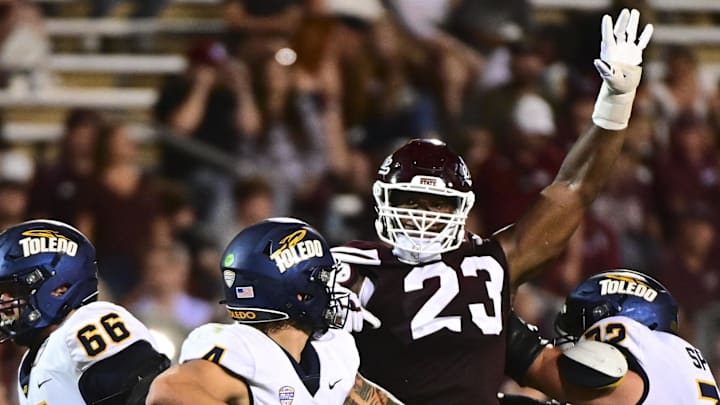 Mississippi State Bulldogs defensive lineman Trevion Williams (23) defends Toledo Rockets quarterback Tucker Gleason (4) during the second quarter at Davis Wade Stadium at Scott Field.