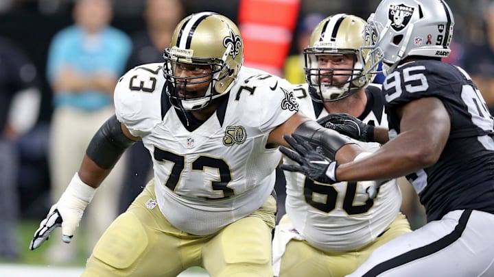 Sep 11, 2016; New Orleans, LA, USA; New Orleans Saints guard Jahri Evans (73) and center Max Unger (60) block Oakland Raiders defensive end Jihad Ward (95) in the second half of their game against the Oakland Raiders at the Mercedes-Benz Superdome. Raiders won, 35-34. Mandatory Credit: Chuck Cook-Imagn Images