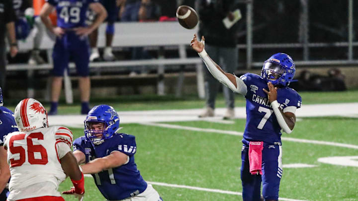 Middletown quarterback Derian Cunningham throws behind protection from Collin Campbell on the offensive line in Middletown's 45-12 win at Cavalier Stadium, Friday, Oct. 4, 2024. Middletown quarterback Derian Cunningham throws behind protection from Collin Campbell on the offensive line in Middletown's 45-12 win at Cavalier Stadium, Friday, Oct. 4, 2024.