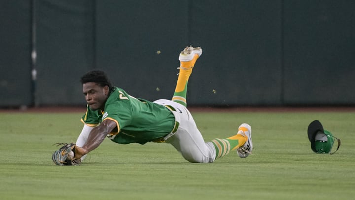 Jul 11, 2025; West Sacramento, California, USA; Athletics outfielder Denzel Clarke (1) attempts to make a diving catch against the Toronto Blue Jays during the ninth inning at Sutter Health Park. Mandatory Credit: Ed Szczepanski-Imagn Images