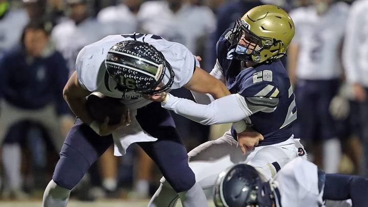 Hoban linebacker Brydon Feister sacks Hudson quarterback Nathan Judy during the first half of a Division II regional semifinal, Nov. 14, 2025. Hoban linebacker Brydon Feister sacks Hudson quarterback Nathan Judy during the first half of a Division II regional semifinal, Nov. 14, 2025.