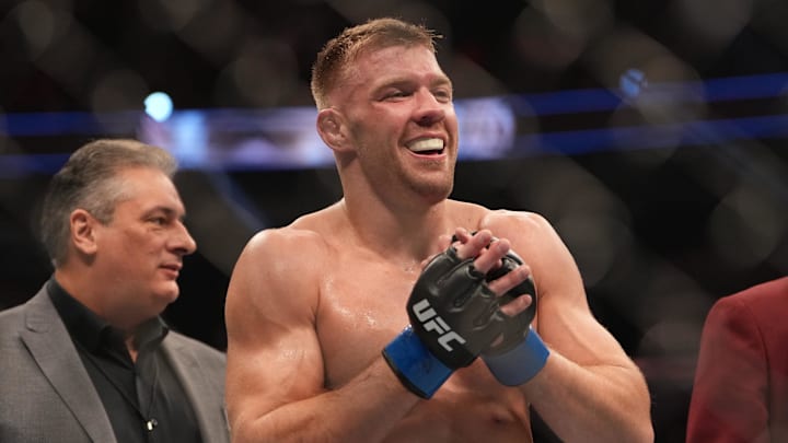 Dec 10, 2022; Las Vegas, Nevada, USA; Dricus Du Plessis (blue gloves) reacts after fighting Darren Till (red gloves) during UFC 282 at T-Mobile Arena.