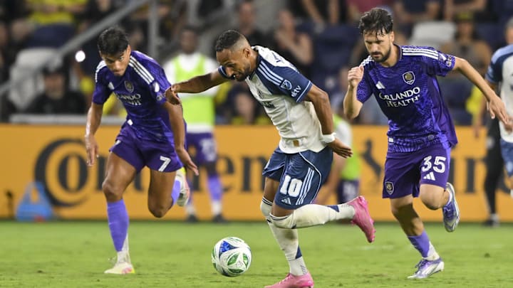 Aug 23, 2025; Nashville, Tennessee, USA;  Nashville SC midfielder Hany Mukhtar (10) splits Orlando City forward Ramiro Enrique (7) and midfielder Joran Gerbet (35) during the second half at Geodis Park. Mandatory Credit: Steve Roberts-Imagn Images