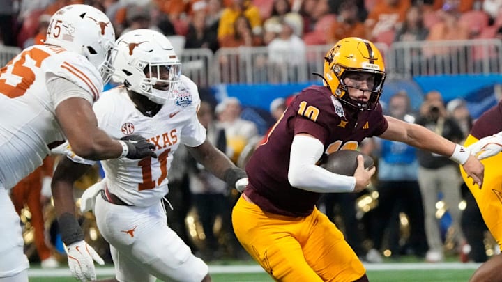 Arizona State quarterback Sam Leavitt (10) scrambles away from Texas linebacker Colin Simmons (11) during the second quarter of the Chick-fil-A Peach Bowl in Atlanta on Wednesday, Jan. 1, 2025.