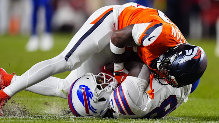 Denver Broncos cornerback Ja'quan McMillian intercepts a pass intended for Buffalo Bills wide receiver Brandin Cooks.