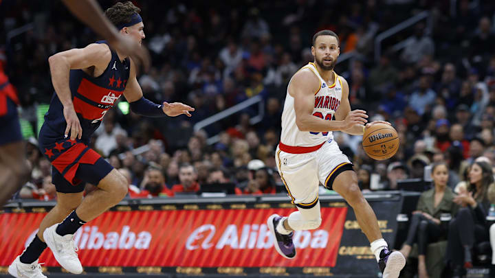 Golden State Warriors guard Stephen Curry (30) drives to the basket as Washington Wizards forward Corey Kispert (24) defends in the second half at Capital One Arena. Mandatory Credit: Geoff Burke-Imagn Images