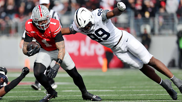 Nov 1, 2025; Columbus, Ohio, USA; Ohio State Buckeyes wide receiver Brandon Inniss (1) runs the ball as Penn State Nittany Lions defensive end Yvan Kemajou (99) makes the tackle during the third quarter at Ohio Stadium. Mandatory Credit: Joseph Maiorana-Imagn Images