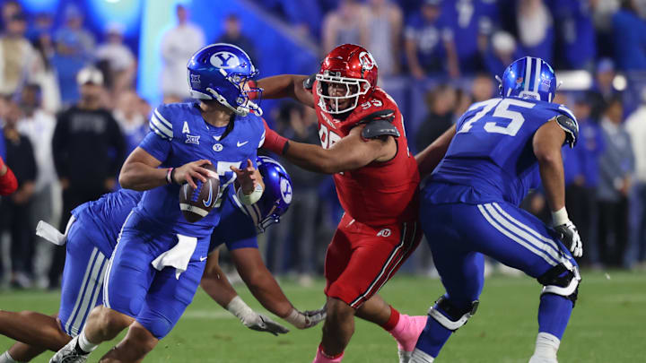 BYU Cougars quarterback Bear Bachmeier (47) rolls out of the pocket against Utah Utes defensive tackle Semi Taulanga (99) during the second half at LaVell Edwards Stadium.