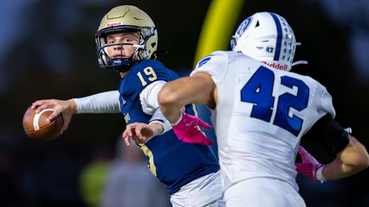 Tri-West Hendricks High School junior Jack Sorgi (19) is pressured in the backfield by Bishop Chatard High School junior Cole Lunsford (42) during the first half of an IHSAA varsity football game, Friday, Oct. 10, 2025, at Tri-West Hendricks High School.