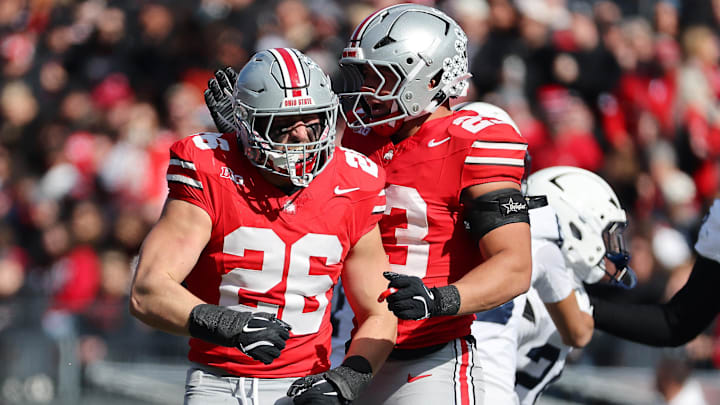 Nov 1, 2025; Columbus, Ohio, USA;  Ohio State Buckeyes linebacker Payton Pierce (26) celebrates his tackle with  linebacker Garrett Stover (23) during the second quarter against the Penn State Nittany Lions at Ohio Stadium. Mandatory Credit: Joseph Maiorana-Imagn Images