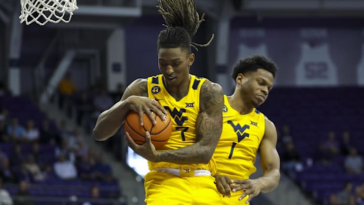 Feb 5, 2025; Fort Worth, Texas, USA;  West Virginia Mountaineers guard Javon Small (7) tries to grab the ball in front of West Virginia Mountaineers guard Joseph Yesufu (1) during the first half against the TCU Horned Frogs at Ed and Rae Schollmaier Arena. Mandatory Credit: Kevin Jairaj-Imagn Images
