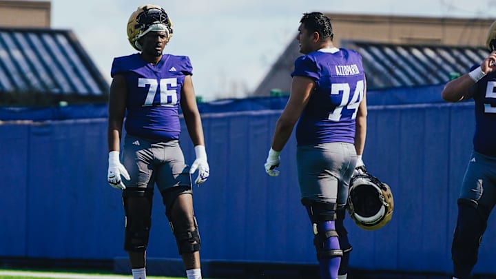 Elishah Jackett (76) chats up Drew Azzopardi during a break in spring ball. 
