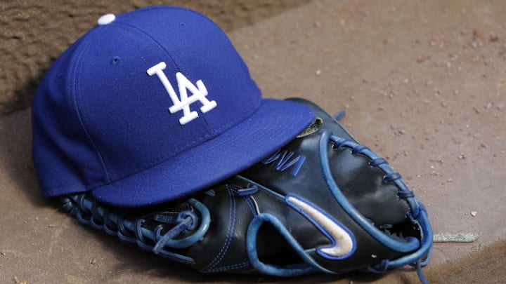 Los Angeles Dodgers hat and glove in the dugout against the Atlanta Braves in the third inning at Turner Field on Aug. 12, 2014. Los Angeles Dodgers hat and glove in the dugout against the Atlanta Braves in the third inning at Turner Field on Aug. 12, 2014.