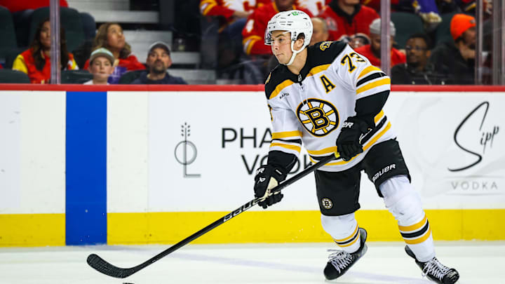 Dec 17, 2024; Calgary, Alberta, CAN; Boston Bruins defenseman Charlie McAvoy (73) controls the puck against the Calgary Flames during the third period at Scotiabank Saddledome. Mandatory Credit: Sergei Belski-Imagn Images