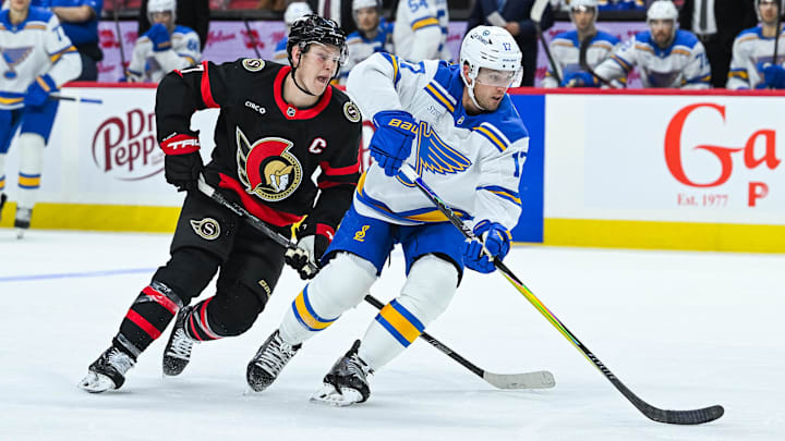 Dec 6, 2025; Ottawa, Ontario, CAN; St. Louis Blues defenseman Cam Fowler (17) defends against Ottawa Senators left wing Brady Tkachuk (7) during the third period at Canadian Tire Centre. Mandatory Credit: David Kirouac-Imagn Images