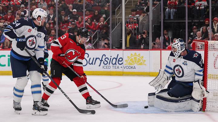 New Jersey Devils left wing Jesper Bratt (63) scores a goal on Winnipeg Jets goaltender Connor Hellebuyck (37) during the second period at Prudential Center. Mandatory Credit: Ed Mulholland-Imagn Images