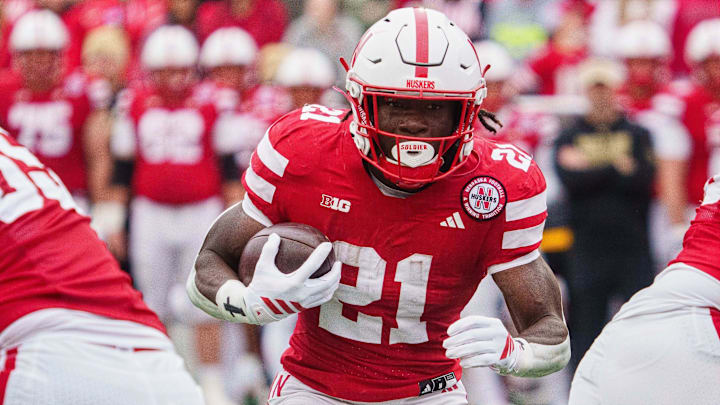 Oct 25, 2025; Lincoln, Nebraska, USA; Nebraska Cornhuskers running back Emmett Johnson (21) runs the ball against the Northwestern Wildcats during the first quarter at Memorial Stadium. Mandatory Credit: Dylan Widger-Imagn Images