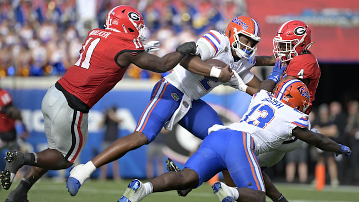 Nov 2, 2024; Jacksonville, Florida, USA; Florida Gators quarterback DJ Lagway (2) is tackled against the Georgia Bulldogs during the first half at EverBank Stadium. Mandatory Credit: Melina Myers-Imagn Images