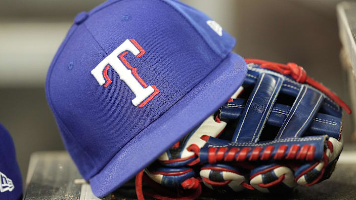 A hat and glove of a Texas Rangers player.